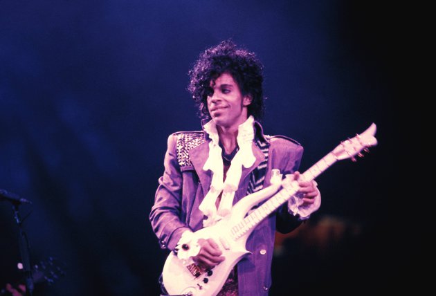 Prince playing guitar at concert